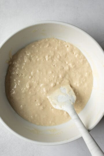 Folding the dry and wet ingredients for a fluffy pancake batter.
