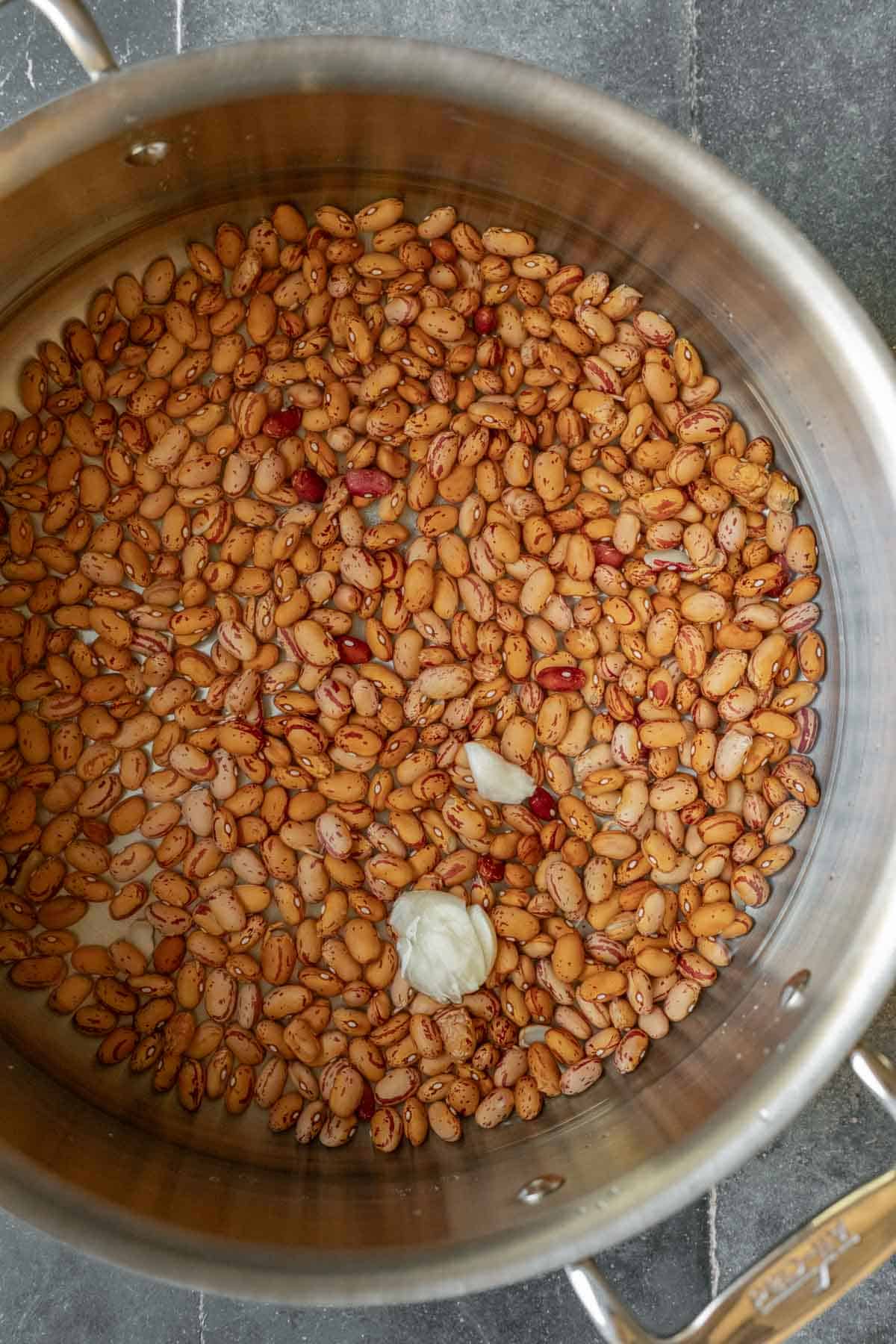 Quick-soaking dry pinto beans in hot water.