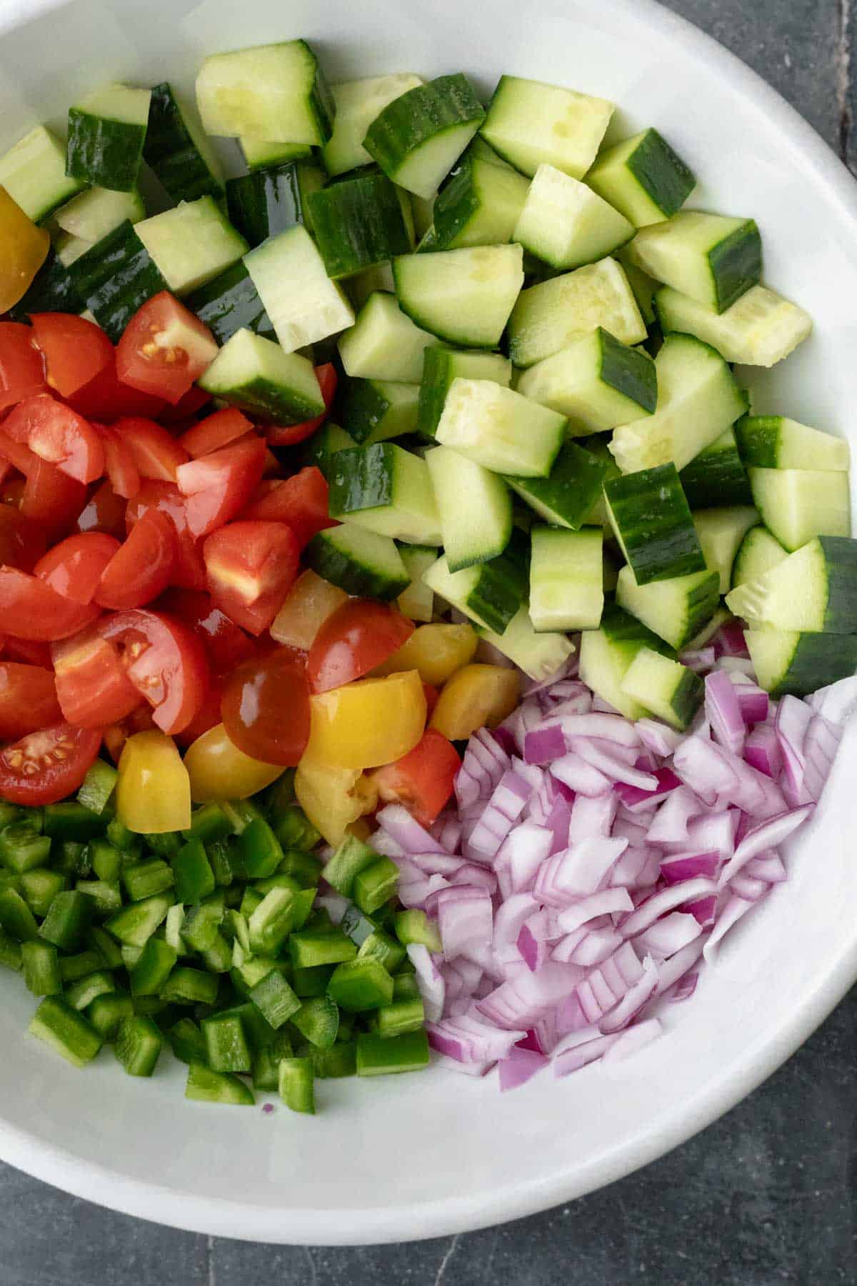 Freshly chopped vegetables for ceviche in a bowl.