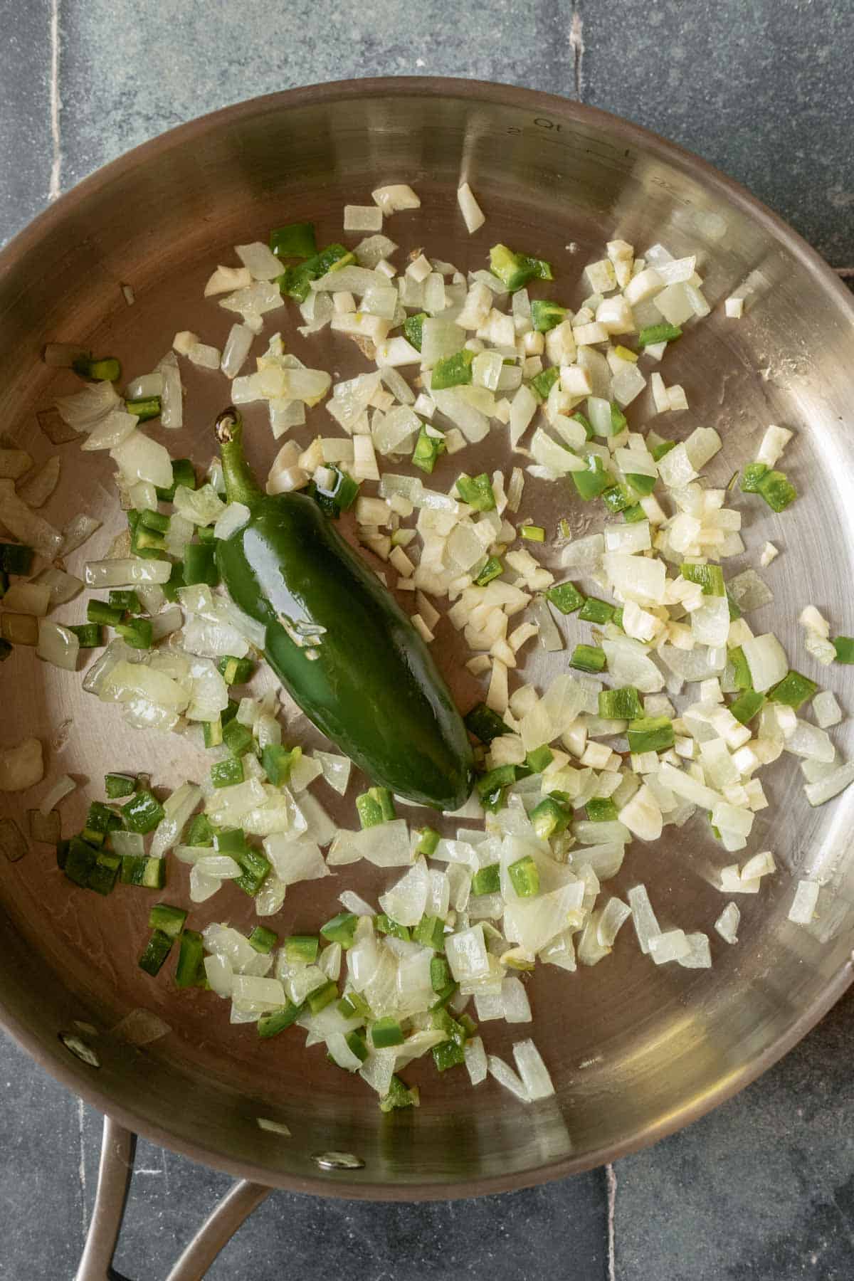 Sauteed onion and jalapeno in oil serve as the base for the beans.