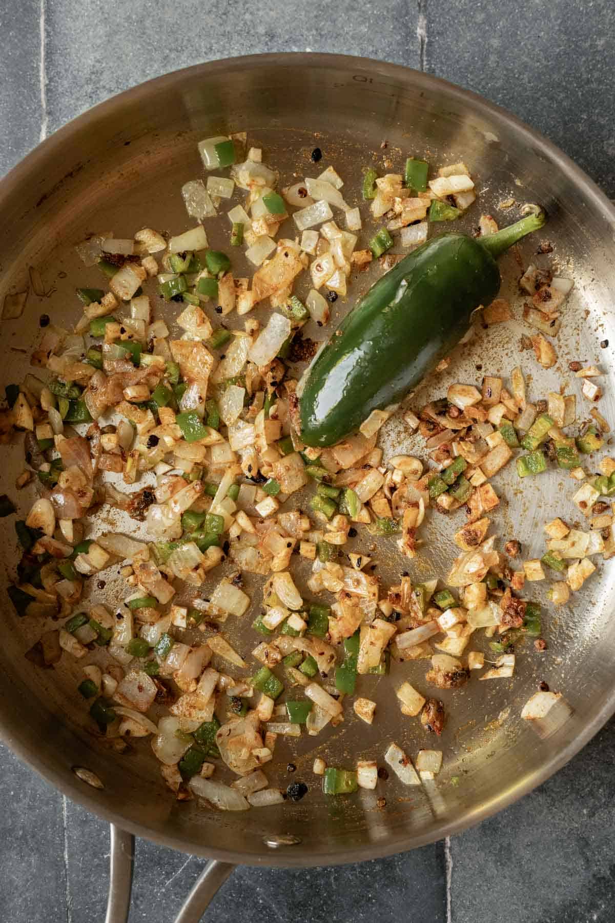Sauteing onion, garlic, jalapeno, and spices.