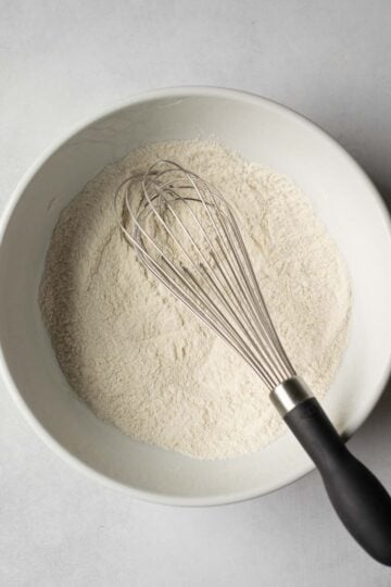 Dry ingredients for vegan pancakes sifted into a bowl.