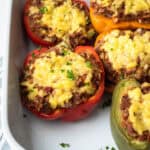 Close up showing the vegan beef filling and cheese in stuffed peppers.