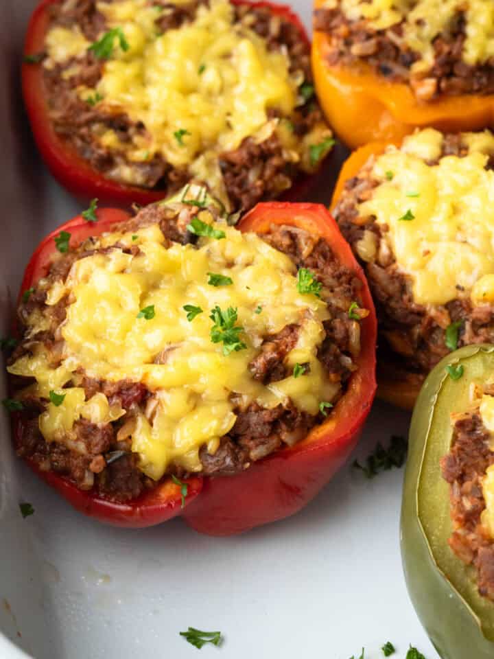 Close up showing the vegan beef filling and cheese in stuffed peppers.
