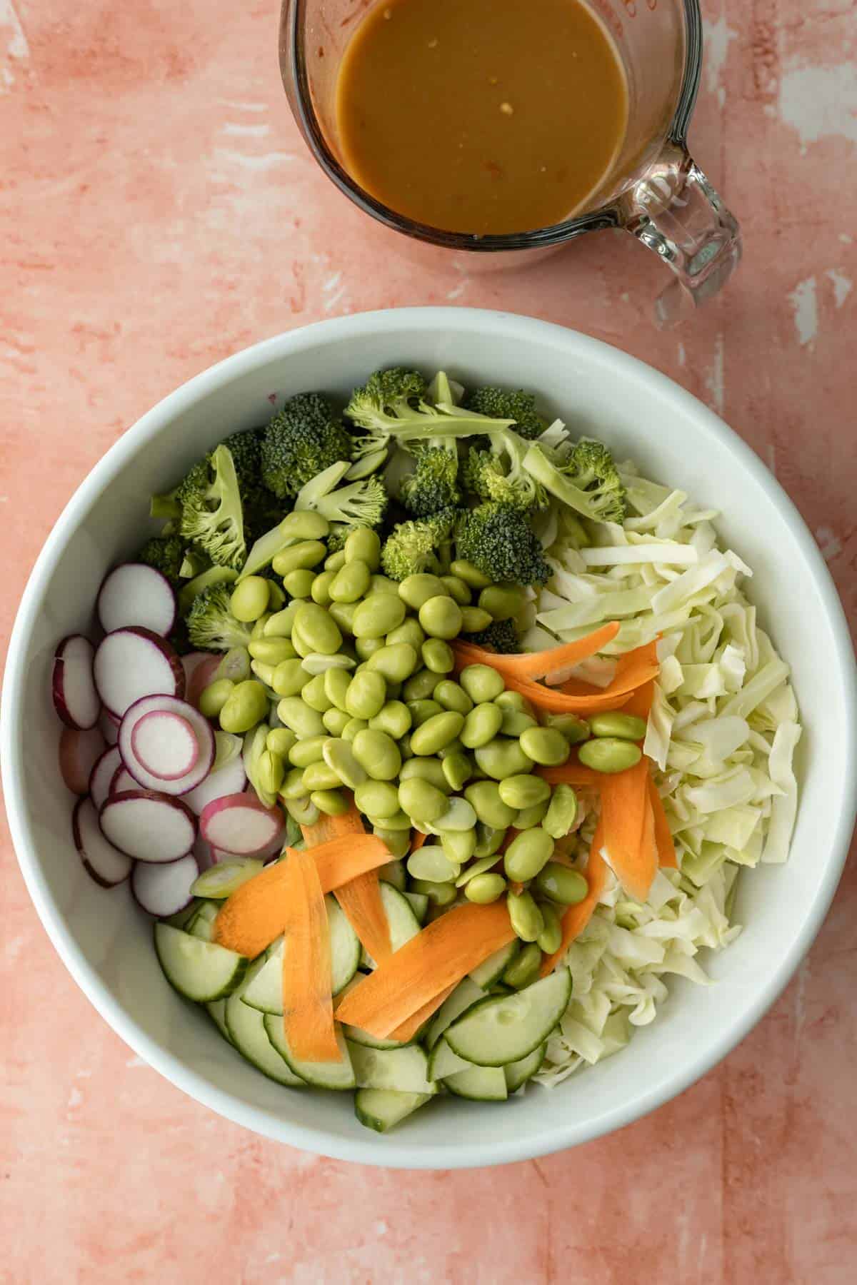 Mixing all of the vegetables together in a large bowl before adding the cooked ramen.