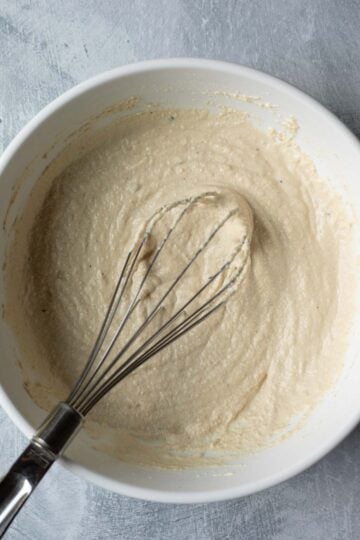 Whisking gluten free flour into the tofu pancake batter.