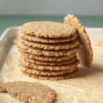 close-up stack of pecan cookies on parchment paper.