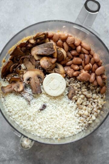 Beans, sauteed mushrooms, barley and other ingredients in a food processor.