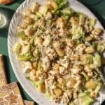 Overhead view of roasted gnocchi salad topped with creamy dressing.