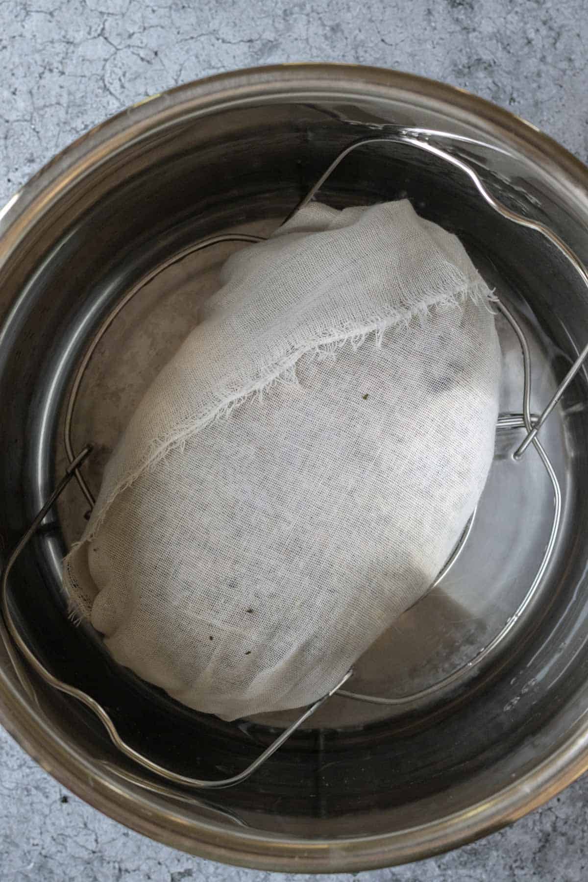 Looking inside an Instant Pot at the wrapped seitan roast.