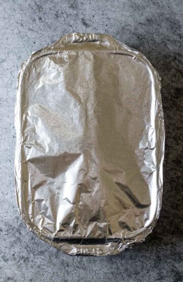 A baking dish covered tightly with aluminum foil.