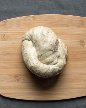 Re-forming the seitan dough into a roast shape.