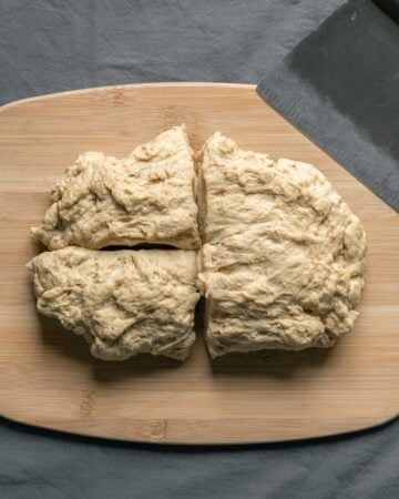 Dividing the seitan into quarters to use one piece as the outer skin.