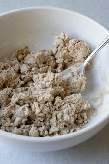 Stirring together the wet and dry ingredients for the cracker dough.