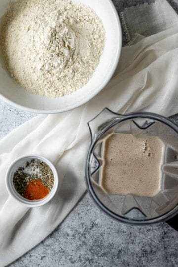 Dry ingredients in a bowl and wet ingredients in a blender.