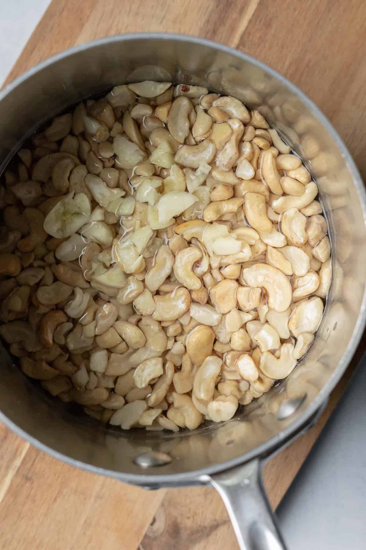 Simmering cashews and garlic in white wine for a spreadable vegan cheese.