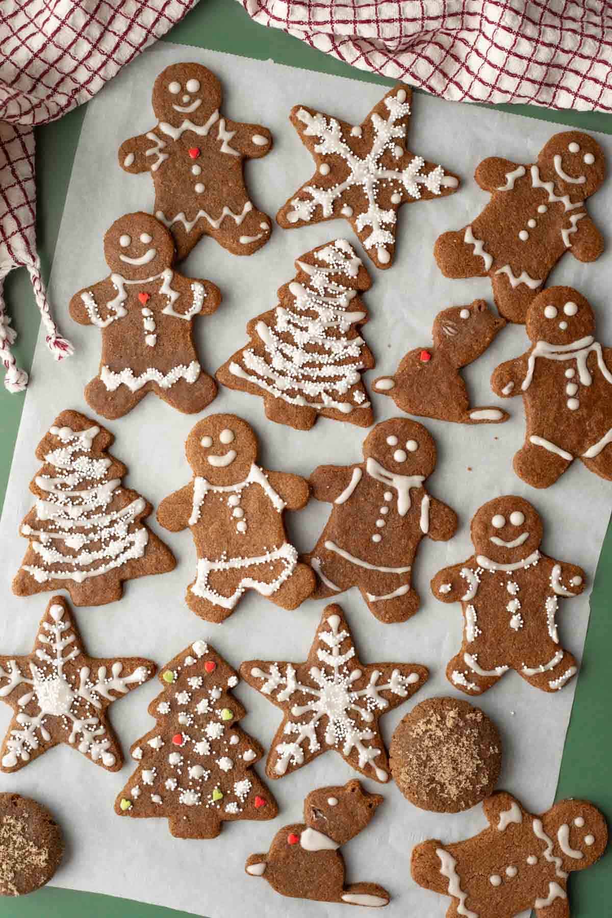 An assortment of almond flour gingerbread cookies on parchment paper.