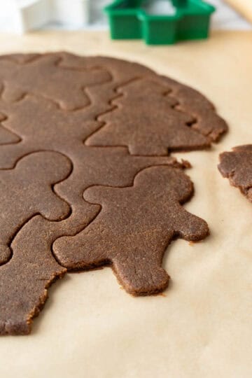 Removing cut-out dough shapes to place on baking sheets.