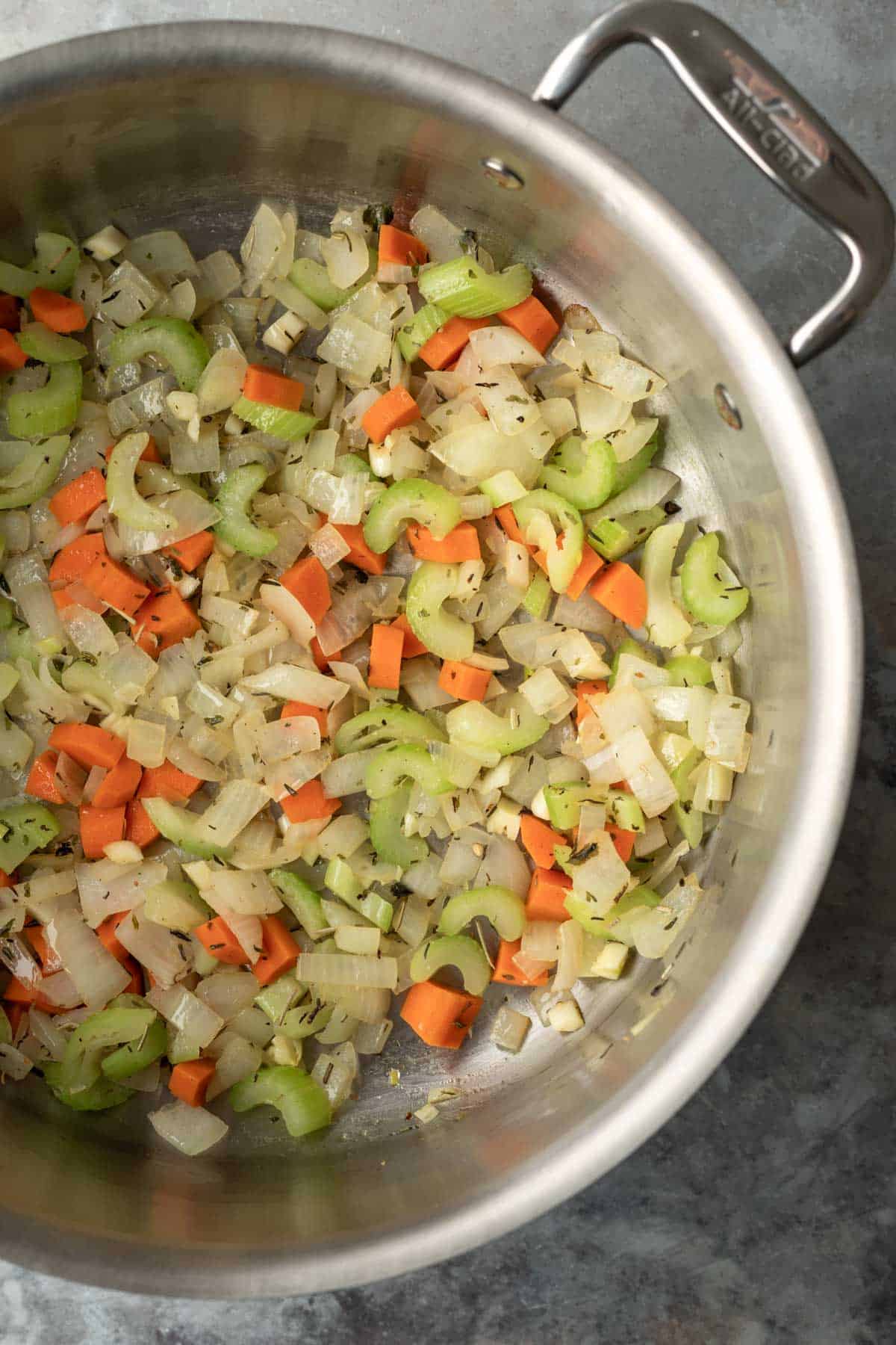 Sautéing veggies in a large soup pot.