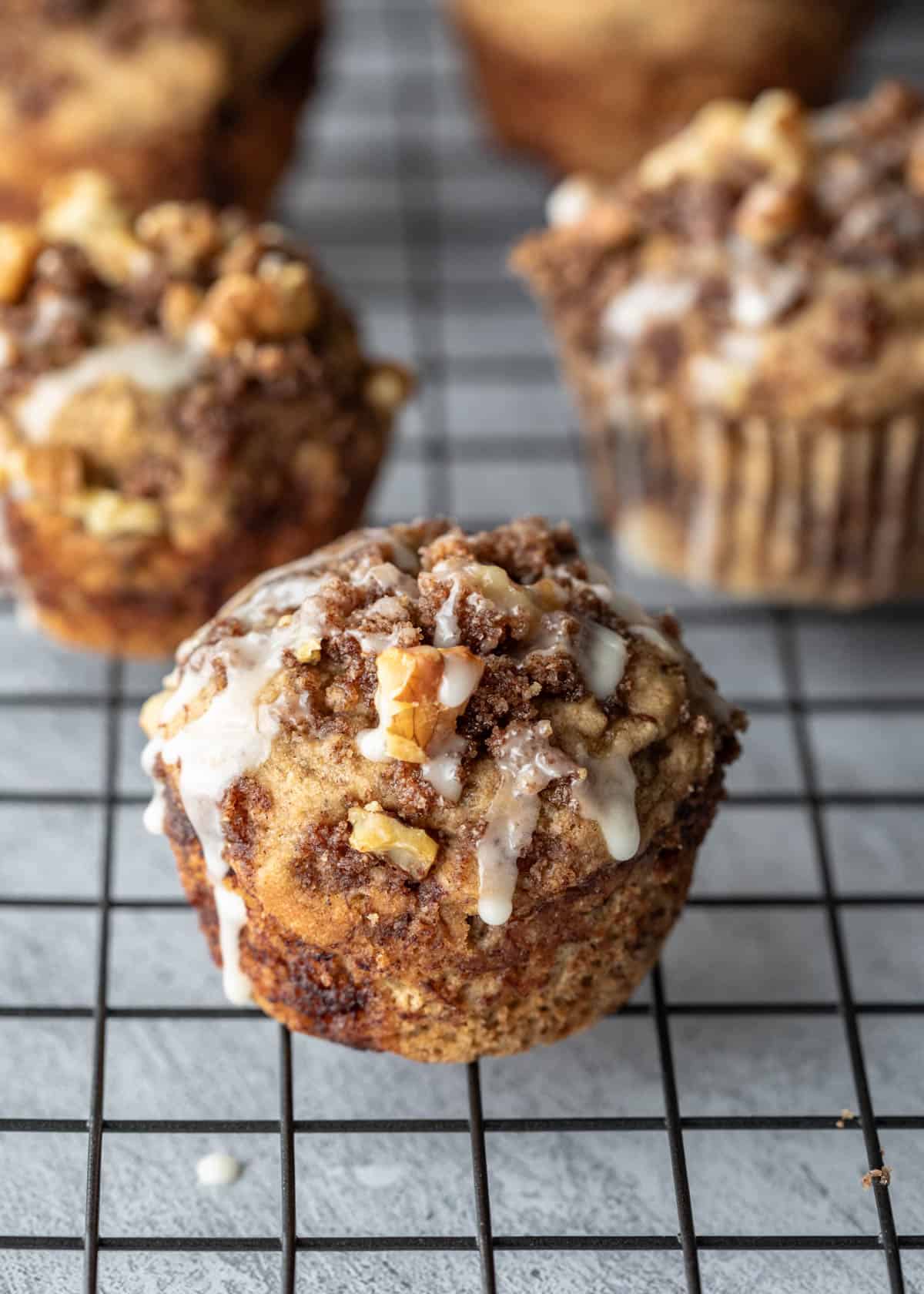 Banana coffee cake muffins on a wire cooling rack.