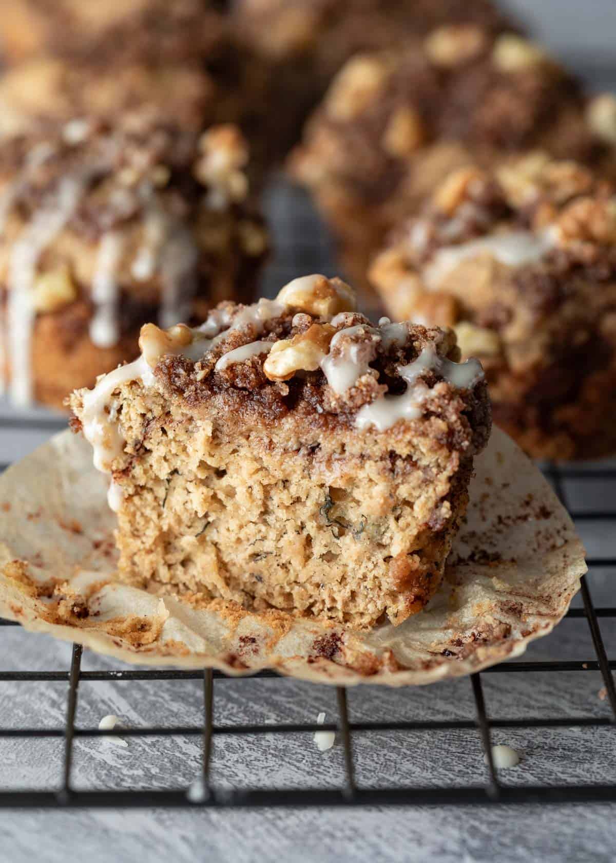 A coffee cake muffin cut in half to show the moist texture inside.