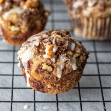 Vegan banana coffee cake muffins on a wire cooling rack.