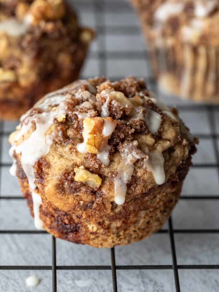 Vegan banana coffee cake muffins on a wire cooling rack.