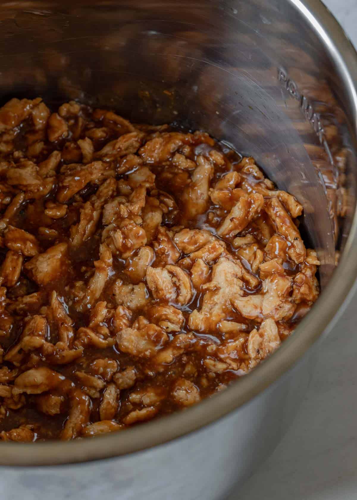 BBQ sauce and soy curls inside the Instant Pot ready to be cooked.