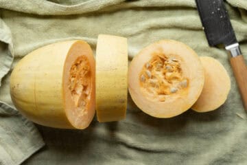 Cut spaghetti squash rings with a knife next to them.