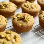 Vegan pistachio muffins on a cooling rack.