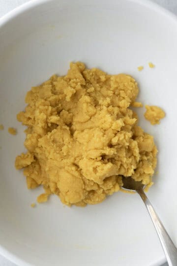 Pale yellow corn flour cookie dough in a bowl.