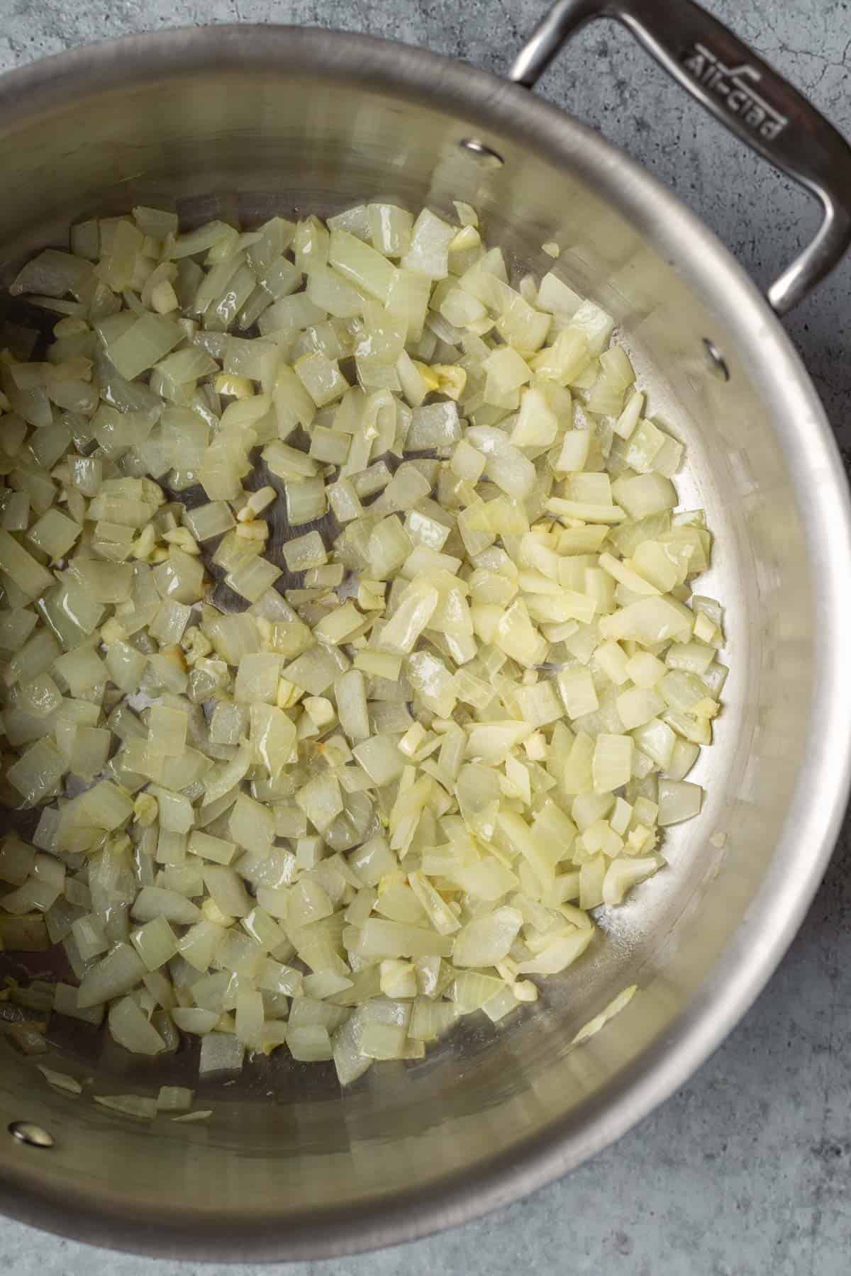 Sauteing onion and garlic in a large pot.