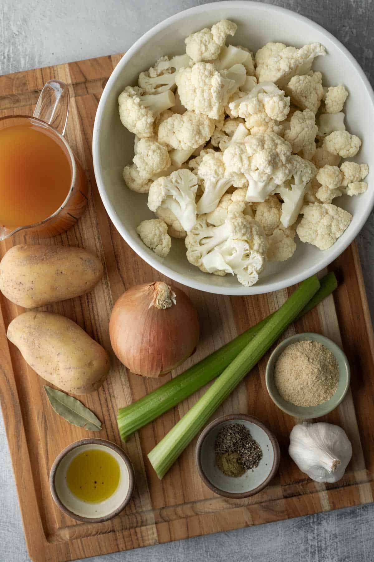 Fresh cauliflower florets and all of the other ingredients needed to make the soup.