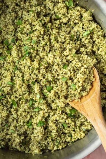 A large pot full of green quinoa made with spinach and cilantro.