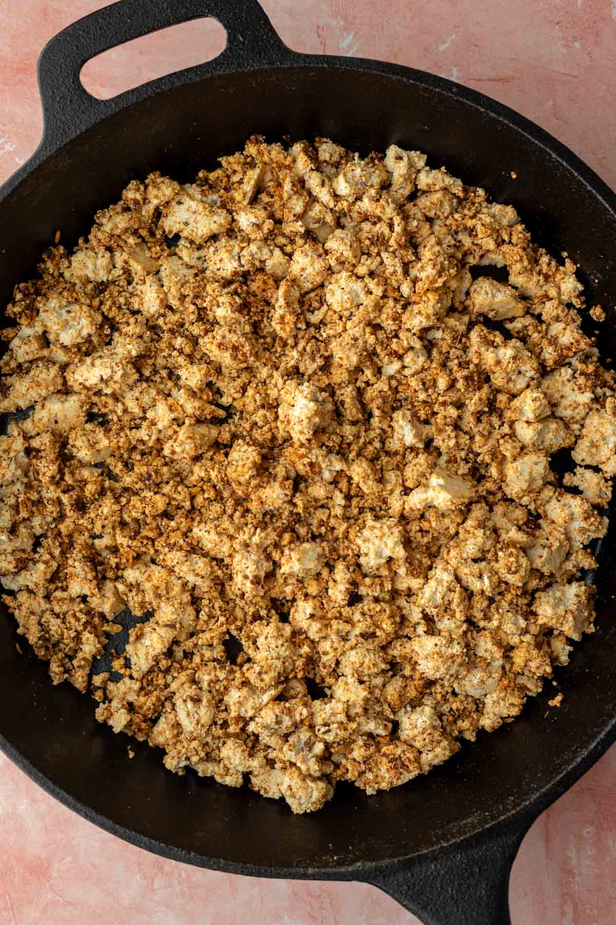 Crumbled tofu added to the skillet.