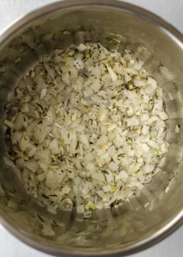 Sauteing onion, garlic, and dried herbs in the Instant Pot.