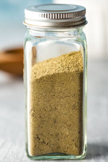 A small spice jar filled with homemade poultry seasoning.