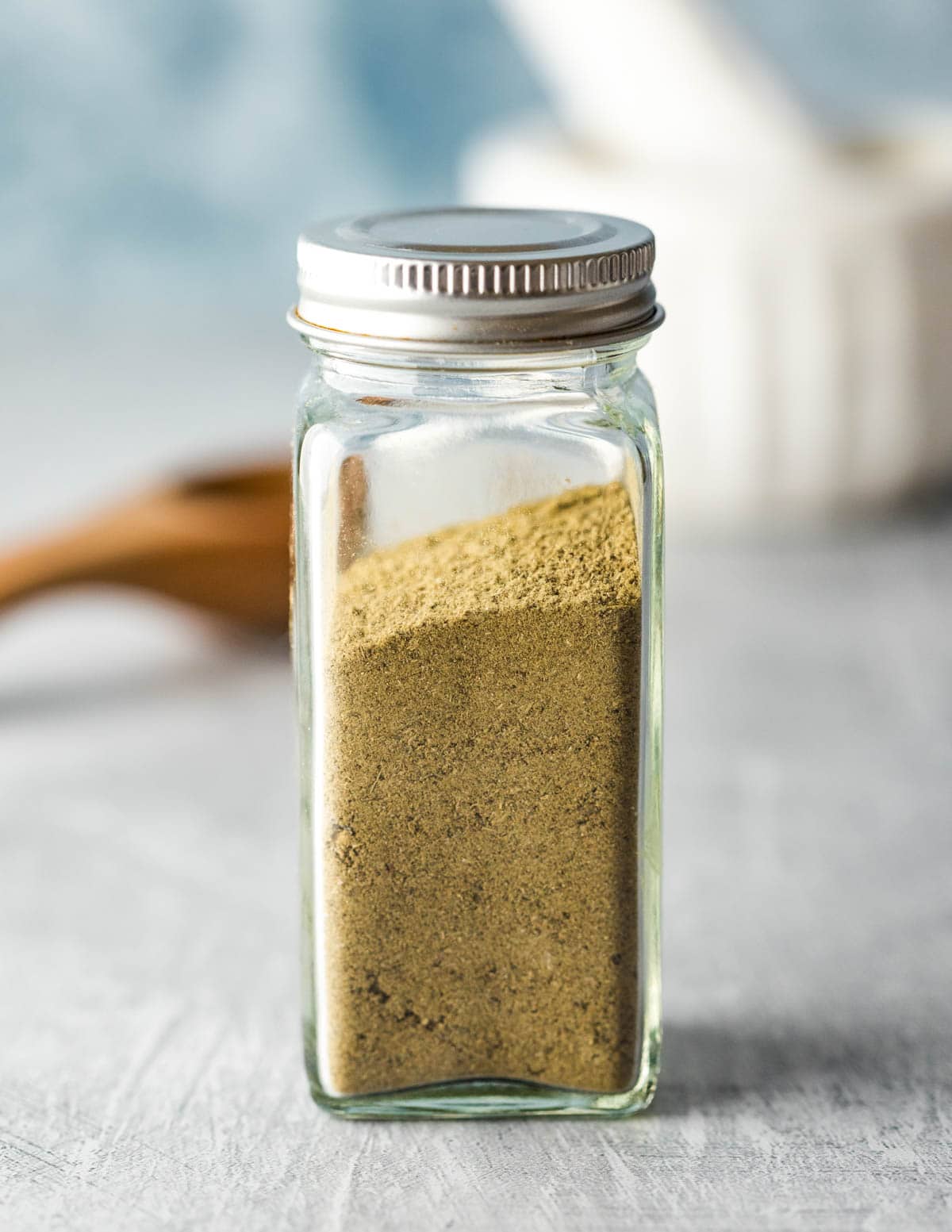 A re-purposed spice jar filled with poultry seasoning blend.