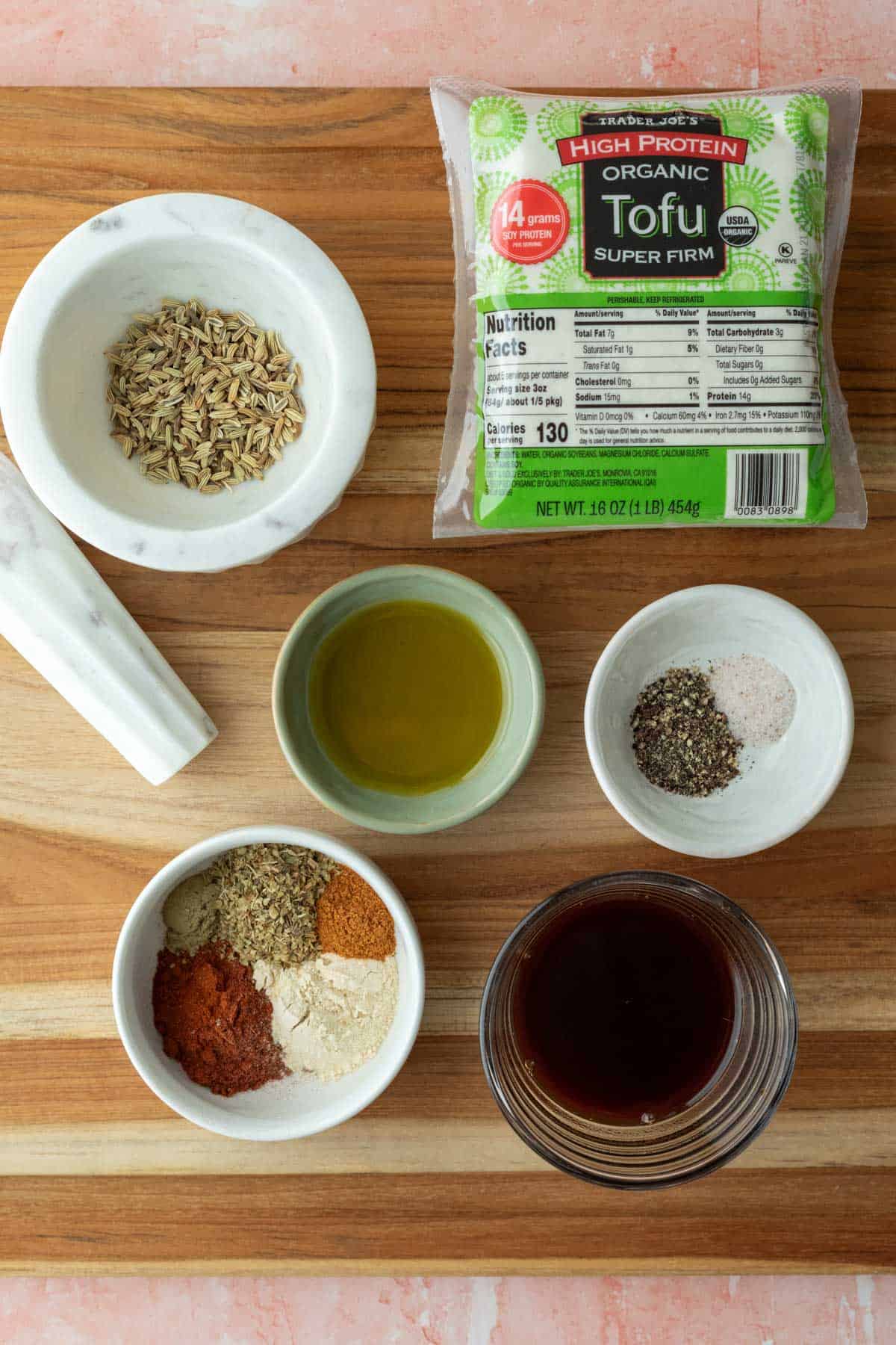 The ingredients needed for tofu sausage laid out on a cutting board.