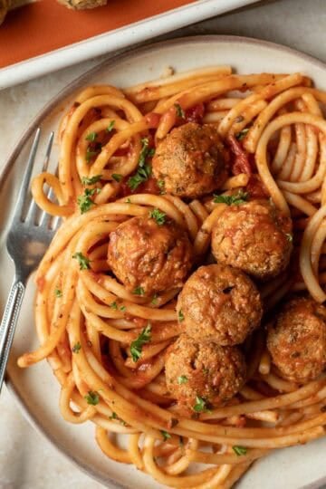 A plate of vegan spaghetti and tofu meatballs.