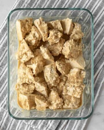 Chunks of tofu resting in a wet batter.