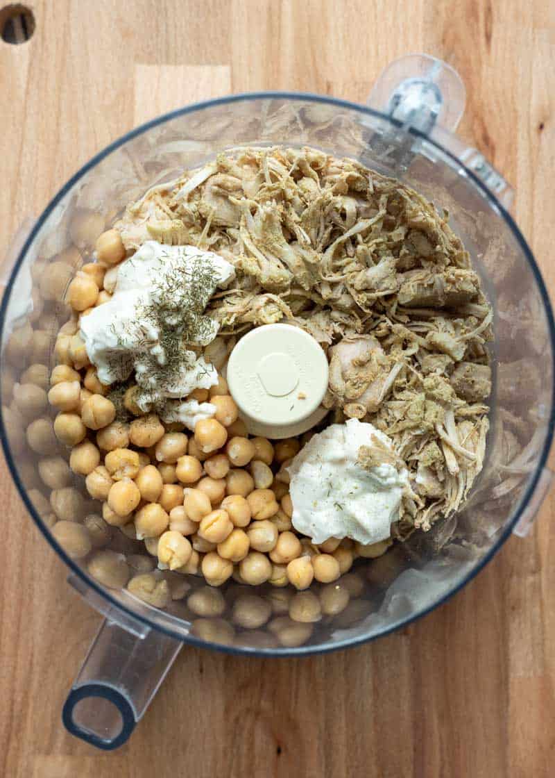 Looking at all of the ingredients inside a large food processor bowl.