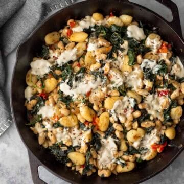 Overhead view of vegan beans and greens with gnocchi.