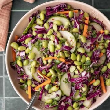 Edamame salad with other colorful veggies in a large serving bowl.