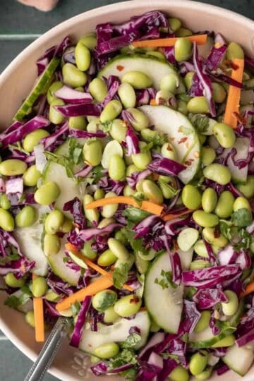 Edamame salad with other colorful veggies in a large serving bowl.