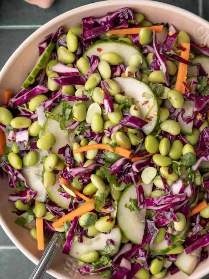 Edamame salad with other colorful veggies in a large serving bowl.