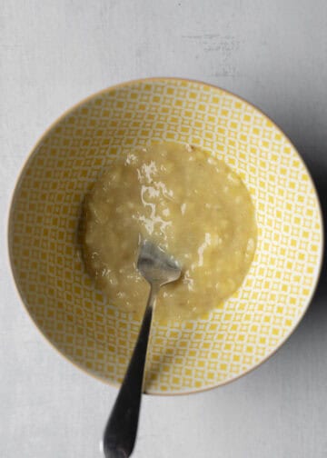 Mashed banana in a small bowl.