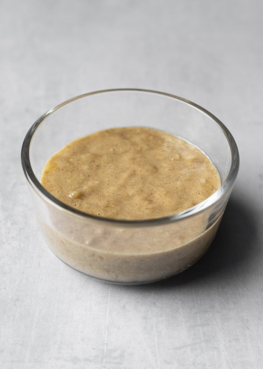 Banana mug cake batter in a small glass dish.