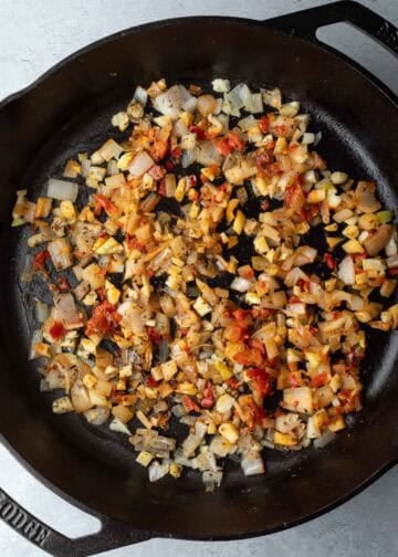Sauteing shallot, garlic, and Calabrian chili paste in a skillet.