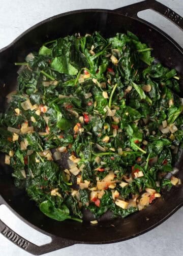 Sauteing kale and spinach with the shallot, herbs, garlic, and Calabrian chili.